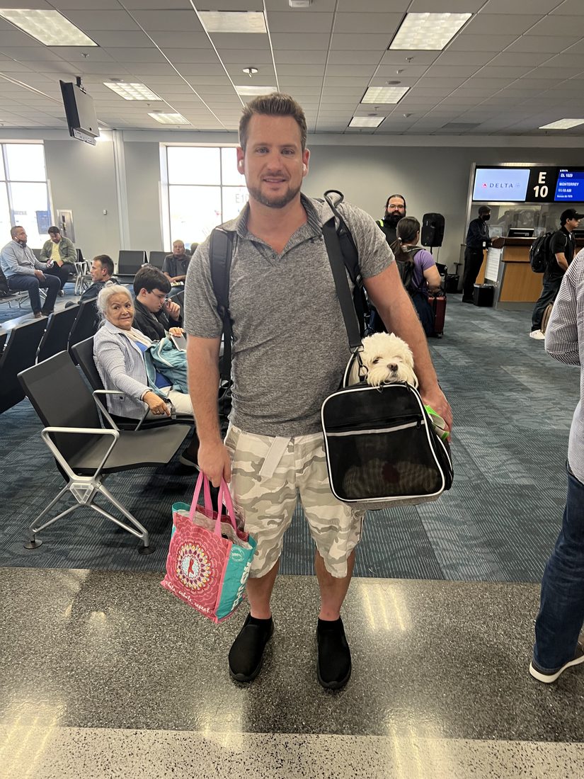 Adam at the gate with Maya in her carrier