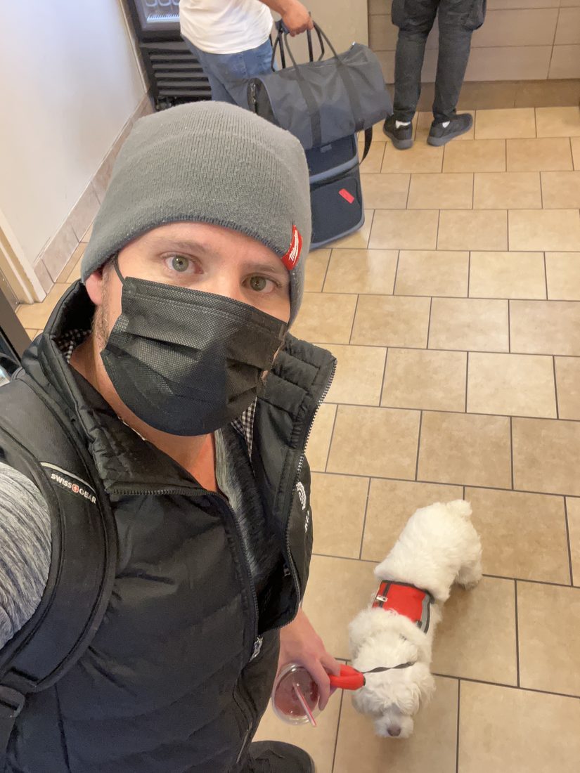 Adam and Maya in her service vest at the airport